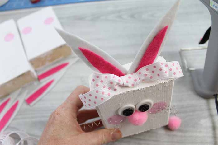 using hot glue to secure pieces to scrap wood bunnies