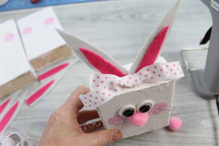 using hot glue to secure pieces to scrap DIY wooden bunnies