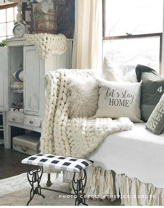Nothing says cozy farmhouse style like this let's stay home throw pillow, paired with cozy blankets