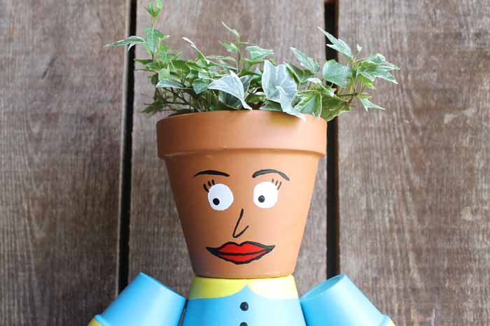 face on a person made of flower pots