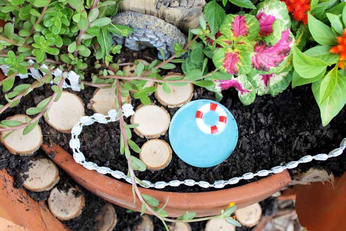 adding a pool to a fairy garden in a clay pot