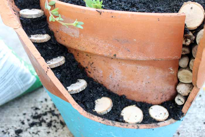 adding wood slices as steps in a fairy garden