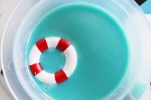 dropping in a miniature life preserver into blue resin