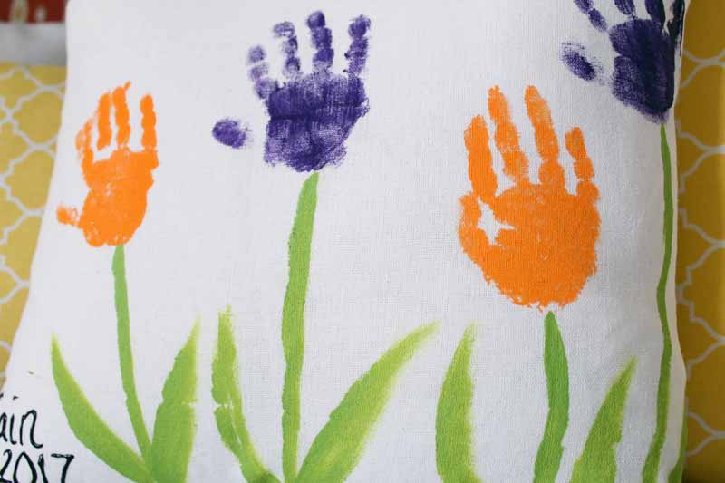 close up of handprint flowers on a pillow