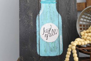 painted jar with hey y'all on a pallet sign