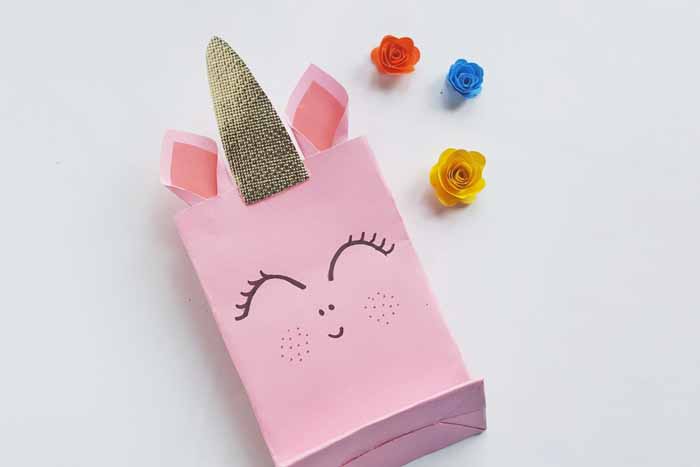 Attach the ears to the inside of the bag, on either side of the unicorn horn. 