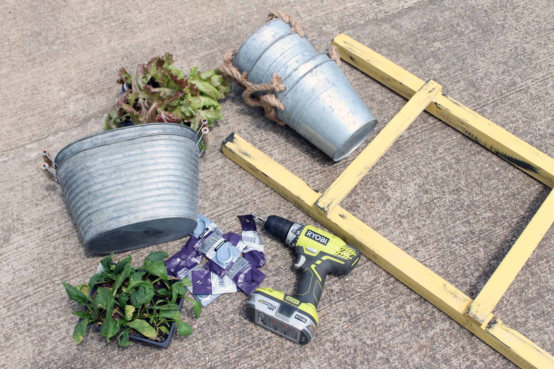 galvanized pots and garden supplies on concrete