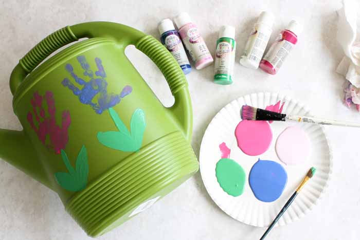 making handprint flowers on a watering can