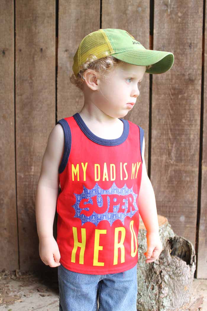 A little boy wearing a hat and a shirt with patterned htv
