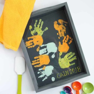 Make this toddler gift for mom in just a few minutes! She will love these sweet hand prints added to a tray for Mother's Day!