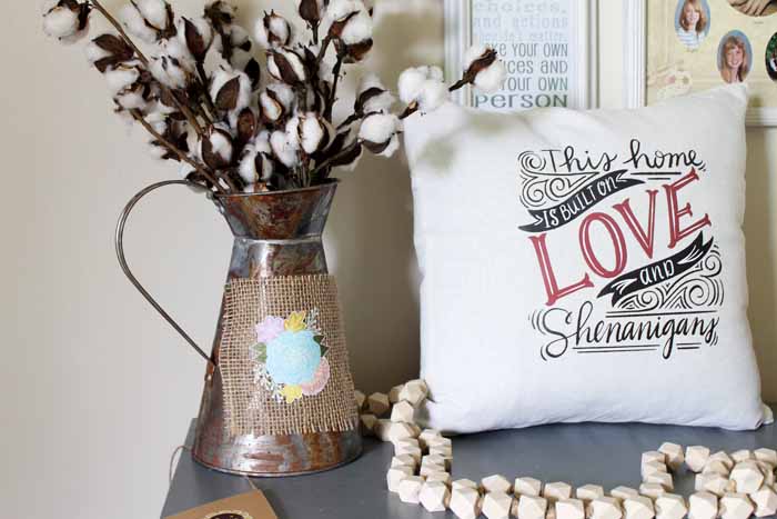 burlap panel on a rustic metal watering can