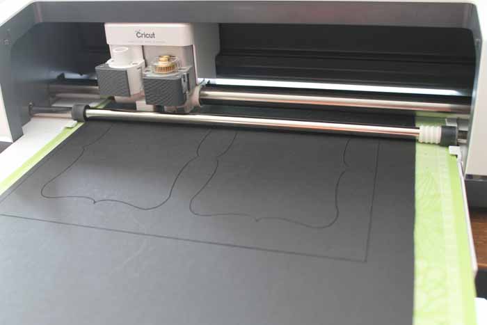 Cricut cutting picture frame mats in a custom shape.