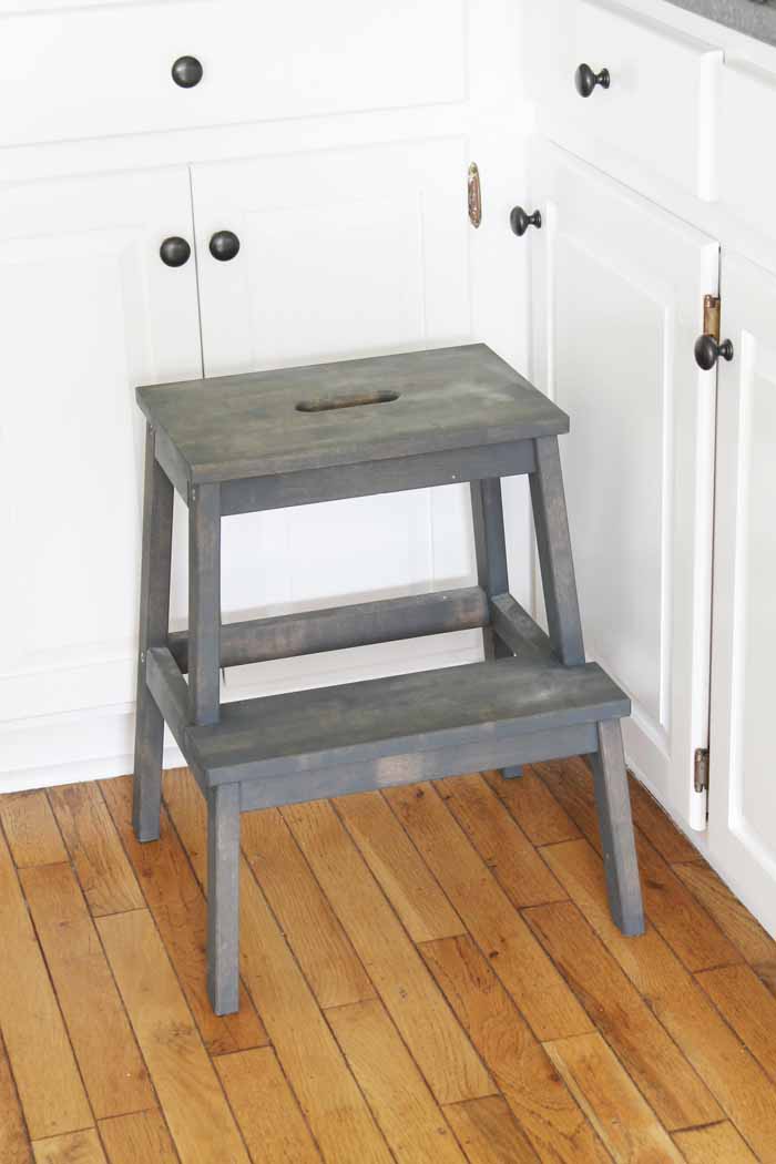 An Ikea stool in a farm kitchen with grey stain.