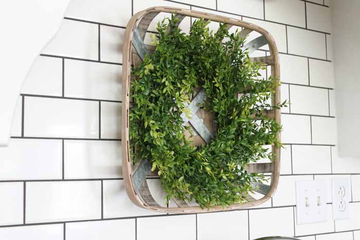 A tobacco basket with a wreath in a farm kitchen.