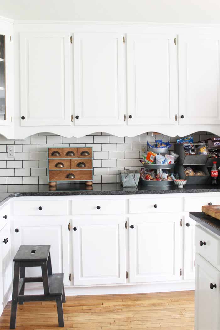 Kitchen with white cabinets and subway tile