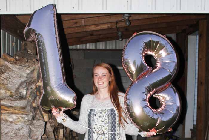 person holding number balloons