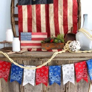 Add a patriotic bunting to your summer decor with bandanas! An easy DIY project that is perfect for 4th of July!