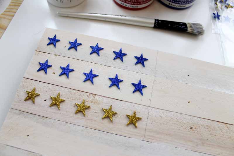 Adding stars by painting a wooden flag