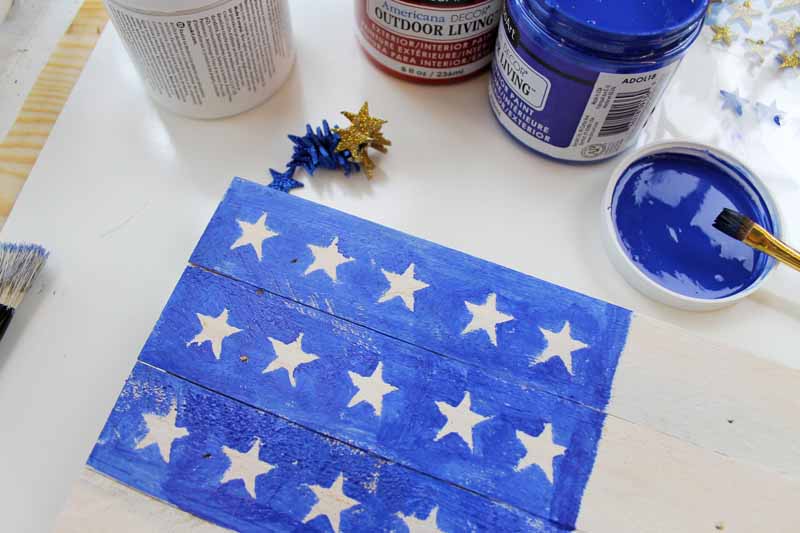 painted blue on a flag from wood with white stars