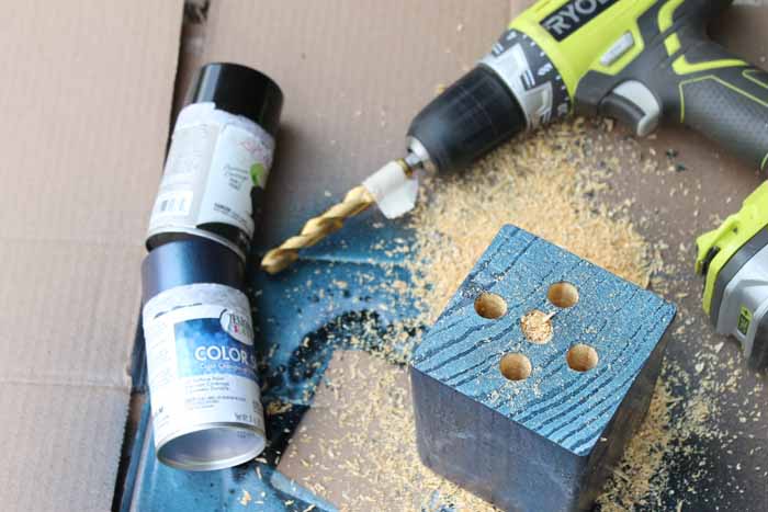 Drilling holes in a wooden pencil holder.