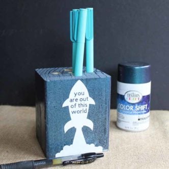 Make this wooden pencil holder for a great Father's Day gift that is easy to make and inexpensive as well! Use your Cricut machine to cut vinyl for the front and use Testors Color Shift paint to give a galaxy look to the entire thing!