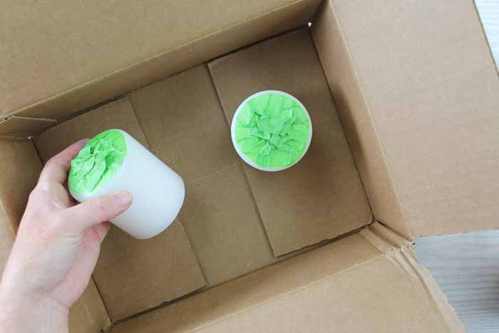 adding taped covered candles to a box