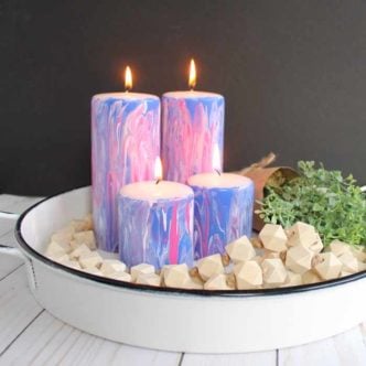 Marbling with acrylic paint is a quick and easy way to add a gorgeous finish to a wide variety of surfaces! Here we are using Testors Marbling Medium to make painted candles that will look great in your home's decor!