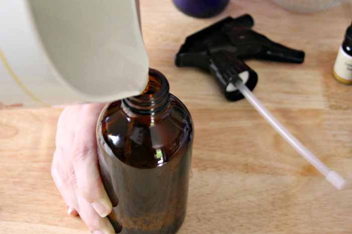essential oil mosquito repellent adding to spray bottle
