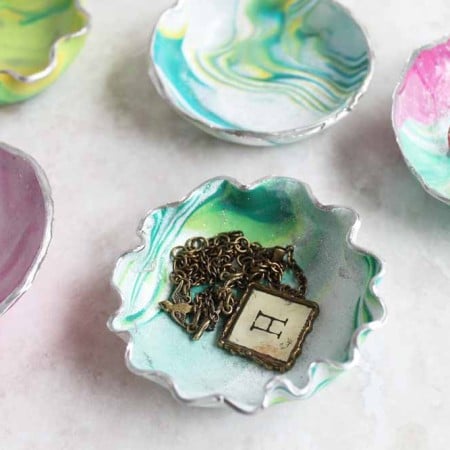 Learn how to make a trinket dish from oven bake clay! These marbled ring bowls make a great gift idea and are perfect for mom!