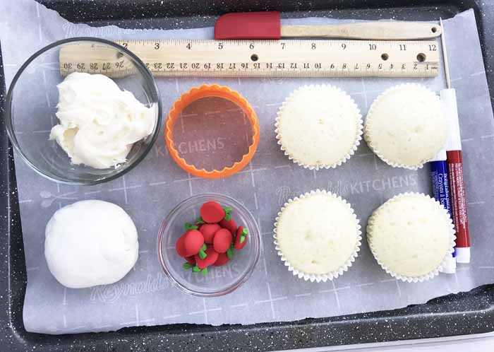 cupcakes and decorating supplies on a tray
