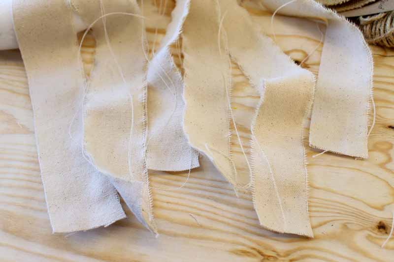 Ripping fabric into strips to add to a wreath form.