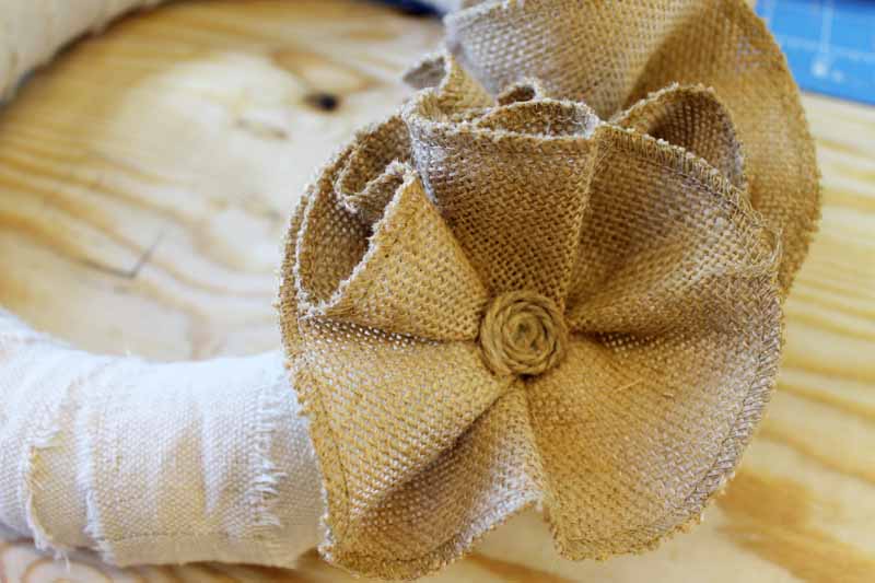 Putting centers in flower on a burlap wreath.