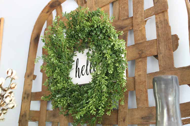 rustic wreath hanging on a tobacco basket