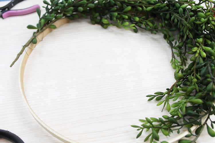 making a farmhouse wreath on a table