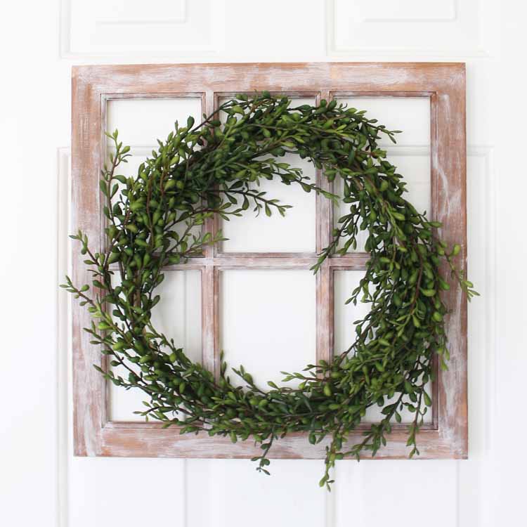 wreath with greenery on a farmhouse window