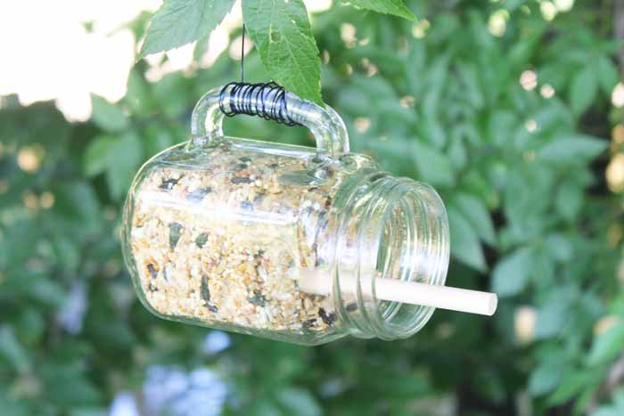 This mason jar bird feeder takes just a few minutes to make and is a great addition to your backyard.