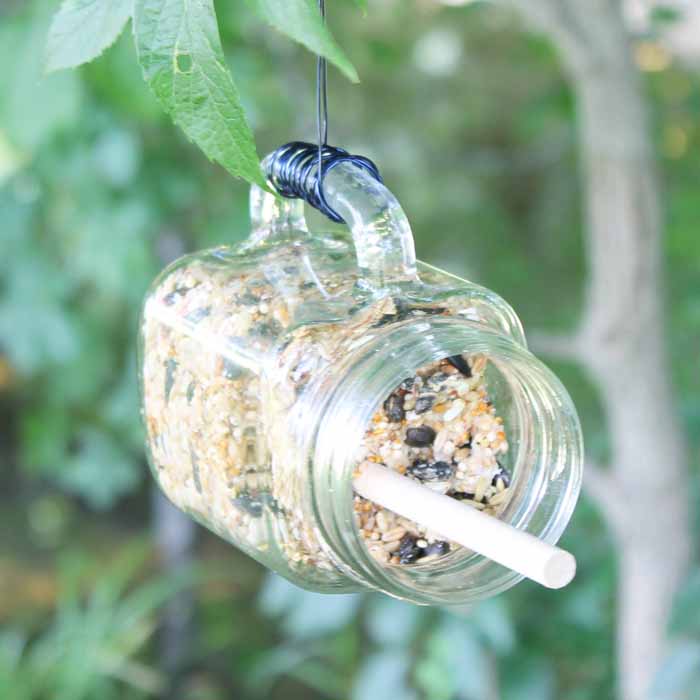 This easy DIY mason jar bird feeder is a simple craft that will bring all kinds of lovely birds to your backyard.