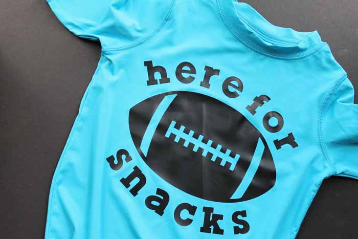 blue shirt with a football and here for snacks htv design