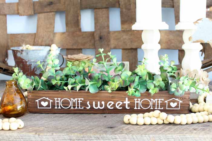 Wooden box with greenery on a table