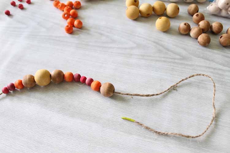 stringing fall colored beads on twine