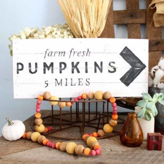 String wood beads to make this gorgeous beaded garland for fall! The wood stain technique makes them extra festive in autumn colors!