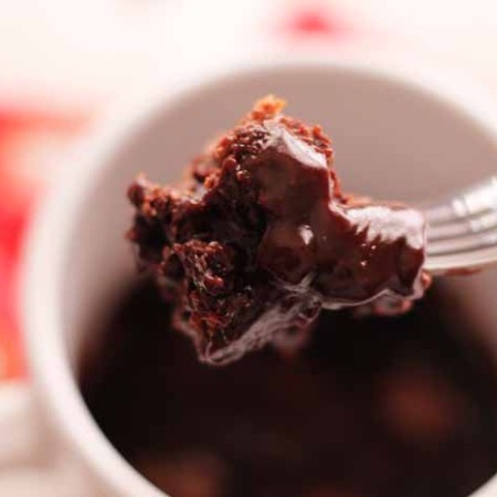 A close up of a bite of mug cake made with kit kat bars