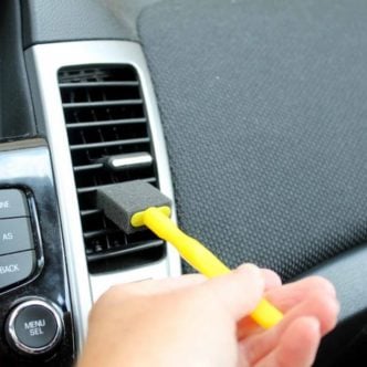 using a foam brush to detail a car