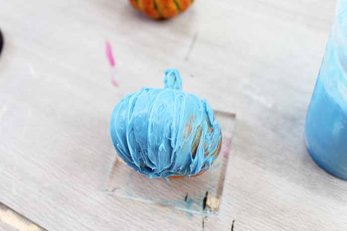 applying mold material to a pumpkin