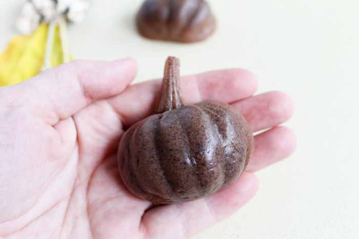 hand holding a soap in a pumpkin shape