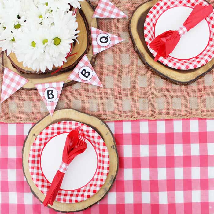 Add the perfect finishing touches to your hot dog bar picnic party with checkered flag banners and wood slice place settings