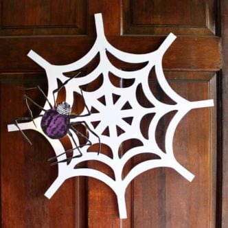 Make this DIY Halloween wreath with a spiderweb for your front door! A fun fall wreath that adds a little fright to your Halloween decorations! It even lights up! #halloween #wreath