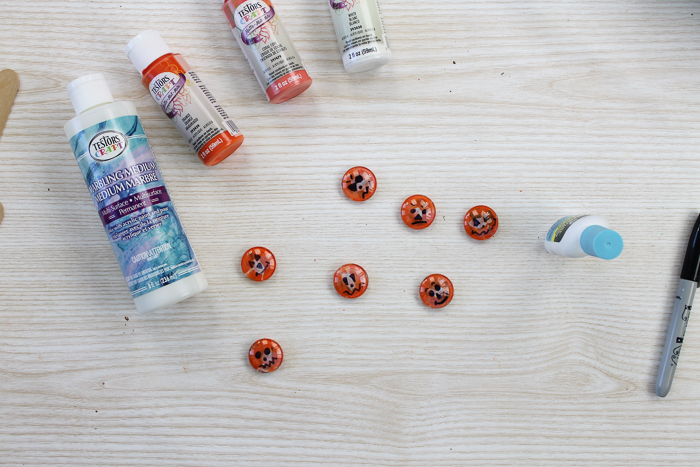 adding pumpkin faces to this halloween magnet craft