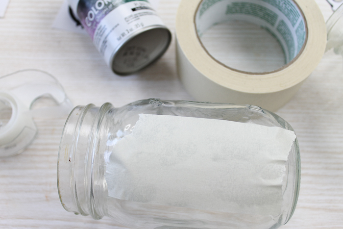 adding masking tape to mason jar