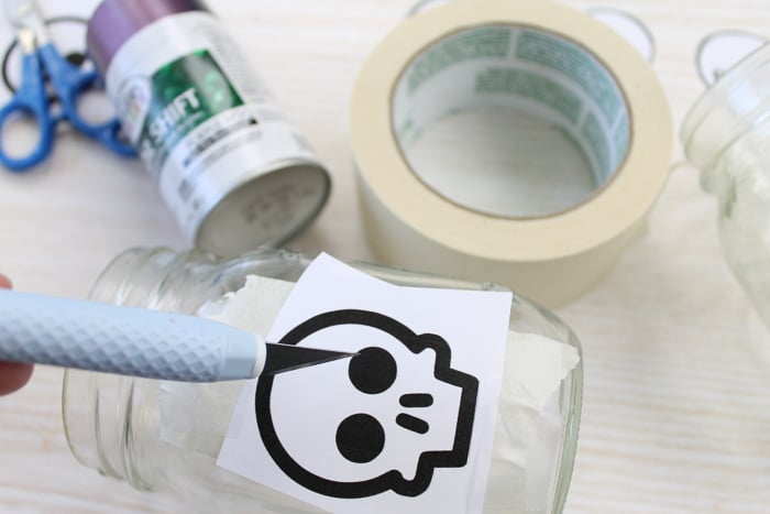 cutting masking tape into shape with a craft knife